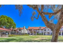 Beautifully maintained townhouse community featuring lush green lawns, mature shade trees, and well-kept landscaping at 6262 E Brown Rd # 65, Mesa, AZ 85205