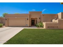 Charming single-story home with a well-manicured lawn and an attached two-car garage at 6313 E Aire Libre Ln, Scottsdale, AZ 85254