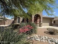 Charming single-story home featuring a neutral color palette, low maintenance yard and barrel tile roof at 703 E Taylor Trl, San Tan Valley, AZ 85143