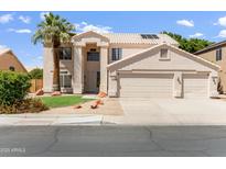 Charming two-story home featuring a three car garage, desert landscaping and a palm tree at 7326 W Pershing Ave, Peoria, AZ 85381