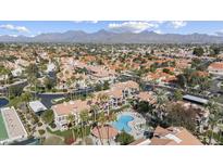 Expansive aerial view showcases community with pool, lush landscaping, and stunning mountain backdrop at 9705 E Mountain View Rd # 1050, Scottsdale, AZ 85258