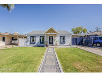 Charming single-story home with beautiful green lawn, stone pathway, and painted accents at 1422 E Windsor Ave, Phoenix, AZ 85006