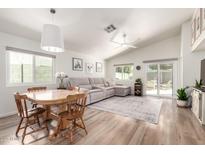 Bright living room featuring wood floors, neutral decor, and a sliding glass door to the backyard at 3269 E San Remo Ave, Gilbert, AZ 85234