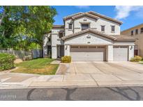 Charming two-story home featuring a three-car garage and well-manicured lawn, creating an inviting curb appeal at 6409 N 11Th Dr, Phoenix, AZ 85013
