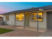 Charming single-story home featuring desert landscaping, covered porch, and a gray roof at 7149 E Jensen St, Mesa, AZ 85207