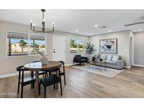 Inviting living room with wood floors, stylish furnishings, and large windows for natural light at 7149 E Jensen St, Mesa, AZ 85207