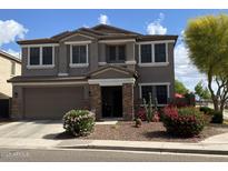Charming two-story home with manicured landscaping, desert plants, and a two car garage at 1194 E Coyote Creek Way, San Tan Valley, AZ 85143