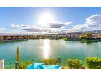 Expansive lake view showcasing the community's waterfront living and mountain views in the distance at 16226 S 11Th Pl, Phoenix, AZ 85048