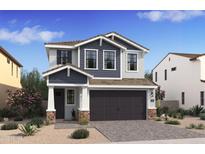 Charming two-story home with gray and white siding, complemented by a spacious two-car garage and a landscaped front yard at 2381 W Los Arboles Pl, Chandler, AZ 85224