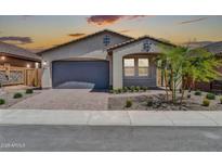 Charming single-story home with a well-manicured front yard and a two car garage at 31435 N 130Th Ave, Peoria, AZ 85383