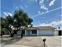 Charming single-story home featuring desert landscaping, mature trees, and a two-car garage in a peaceful neighborhood at 3225 E Monica Ave, Phoenix, AZ 85032