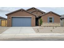 Charming single-Gathering home featuring a two-car garage, stone accents, desert landscaping, and a well-maintained front yard at 361 S Calle Miguel --, Casa Grande, AZ 85194
