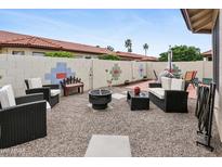 Cozy backyard featuring gravel, mature landscaping, stylish outdoor seating, and a fire pit at 542 S Higley Rd # 52, Mesa, AZ 85206