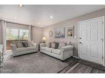 Comfortable living room featuring a gray sofa set, carpeted floors, and access to an outdoor balcony at 5877 N Granite Reef Rd # 2240, Scottsdale, AZ 85250