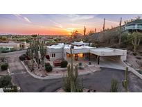 An eye-level exterior featuring Southwestern architecture, desert landscaping, and a sunset background at 612 N Signal Butte Rd, Mesa, AZ 85207