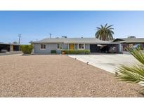 Charming single-story home with a well-manicured yard and a convenient carport at 615 E Mckellips Rd, Tempe, AZ 85288