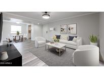 Bright living room featuring modern decor, light gray walls, stylish furniture, and durable wood-look flooring at 8260 E Arabian Trl # 257, Scottsdale, AZ 85258