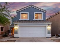 Charming two-story home featuring a large two car garage, beautiful blue siding, and a lovely tiled roof at 10831 E Azalea Ave, Mesa, AZ 85208