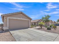 Tan home with a two car garage, desert landscaping and a concrete driveway at 12605 W Dreyfus Dr, El Mirage, AZ 85335