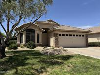Charming single-story home featuring a well-manicured lawn and a two-car garage at 1424 W Mead Dr, Chandler, AZ 85248