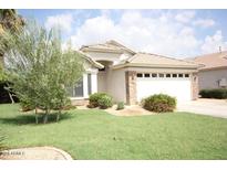 Charming single-story home with well-maintained lawn and desert landscaping, plus a 2-car garage at 1424 W Mead Dr, Chandler, AZ 85248
