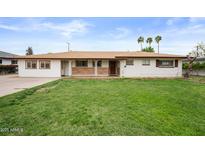 Charming single-story home with a well-maintained lawn, a stone accent, and a welcoming facade at 1431 E 1St St, Mesa, AZ 85203