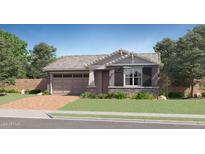 Charming single-story home featuring a two-car garage, brick driveway, and a beautifully landscaped front yard at 15797 W Kendall St, Goodyear, AZ 85338