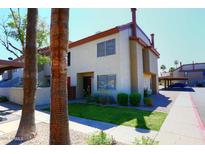 Charming two-story condo features a well-maintained lawn and stucco facade at 2040 S Longmore St # 7, Mesa, AZ 85202