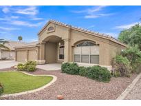 Inviting single-story home with a charming facade, arched entryway, and well-maintained desert landscaping at 2343 E Kempton Rd, Chandler, AZ 85225