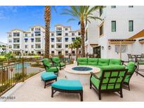 Relaxing outdoor lounge area with a cozy fire pit and pool access, surrounded by lush landscaping and resort style living at 2511 W Queen Creek Rd # 244, Chandler, AZ 85248