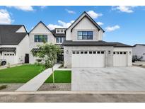 Stunning two-story home featuring a pristine lawn and a three-car garage with a light brick exterior at 26655 S 169Th Pl, Queen Creek, AZ 85142