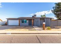 Charming single-story home with grey exterior, walkway, and well-maintained landscaping at 3021 E Larkspur Dr, Phoenix, AZ 85032