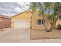A cozy home featuring an attached garage, landscaped yard, and a classic tile roof at 3252 E Maldonado Dr, Phoenix, AZ 85042