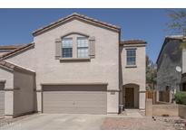 Charming two-story home with a two-car garage and desert landscaping at 7028 W Lincoln St, Peoria, AZ 85345