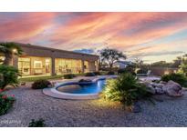 Resort-style backyard featuring a free-form pool, beautiful desert landscaping, and a covered patio, perfect for entertaining at 7848 E Parkview Ln, Scottsdale, AZ 85255