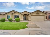 Charming single-story home featuring a manicured lawn, mature bushes, and a two-car garage at 8531 E Natal Cir, Mesa, AZ 85209