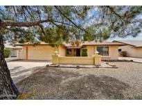 Charming single-story home with a well-maintained front yard and a two car garage at 9645 W Kimberly Way, Peoria, AZ 85382
