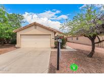 Charming single-story home with a well-maintained front yard and attached two-car garage at 12132 W Dahlia Dr, El Mirage, AZ 85335