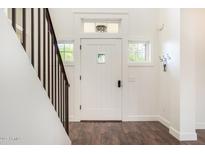 Inviting foyer featuring hardwood floors and a staircase leading to upper level at 122 W Cottage Ln, Tempe, AZ 85282