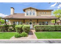 Charming two-story home featuring a covered front porch, lush landscaping, and a welcoming entrance at 122 W Cottage Ln, Tempe, AZ 85282