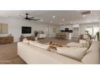 Bright living room with modern furnishings open to a spacious kitchen and dining area at 6607 S Mitchell Dr, Tempe, AZ 85283