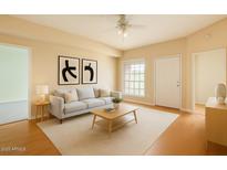 Bright living room features neutral decor, a large window, and modern furnishings for a cozy, inviting space at 8140 N 107Th Ave # 107, Peoria, AZ 85345