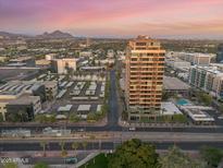 Stunning aerial view of high-rise community with city views and desert mountain backdrop at sunset at 1 E Lexington Ave # 1302, Phoenix, AZ 85012