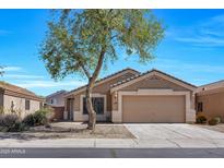 Charming single-story home featuring a well-manicured front yard and an attached two-car garage at 12469 W Hearn Rd, El Mirage, AZ 85335