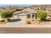 Beautiful single-story home featuring a well manicured xeriscaped front yard and a spacious three car garage at 13806 W Remuda Dr, Peoria, AZ 85383