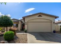 Charming home with a two-car garage, well-manicured yard, and appealing desert landscaping at 15246 N 138Th Ln, Surprise, AZ 85379
