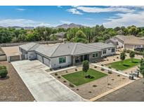 Expansive single story home featuring desert landscaping, a concrete driveway, and a gray tile roof at 19935 E Via Del Palo --, Queen Creek, AZ 85142