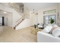 Bright living room with tiled floors, staircase, and plenty of natural light for a warm and inviting atmosphere at 25825 N 65Th Ave, Phoenix, AZ 85083