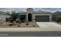 Charming single-story home featuring a two-car garage and desert landscaping at 30395 W Mitchell Ave, Buckeye, AZ 85396