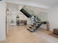 Bright living space with open staircase, glass railings, and stylish dining area bathed in natural light at 309 E Huntington Dr, Tempe, AZ 85282